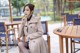 A woman sitting at a table in a park.