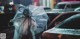 A person holding an umbrella in the middle of a busy city street.